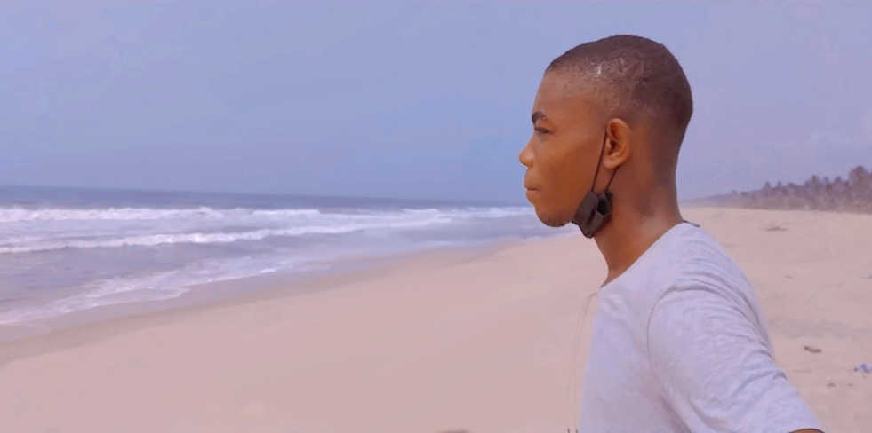 a picture of michael eise at the beach, staring into the water